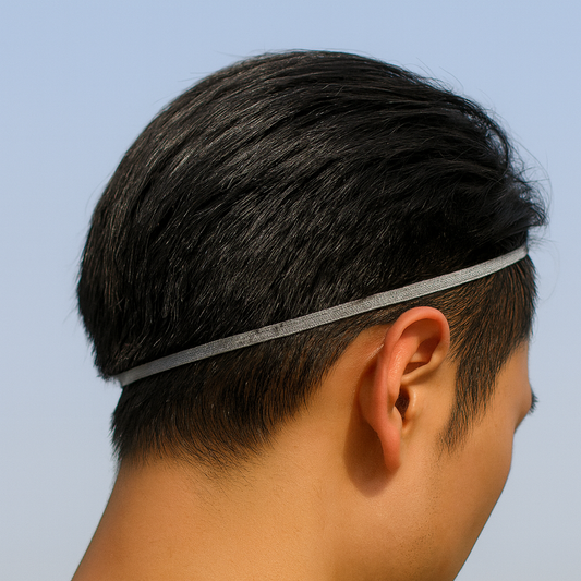 Person wearing a thin headband against a clear blue sky
