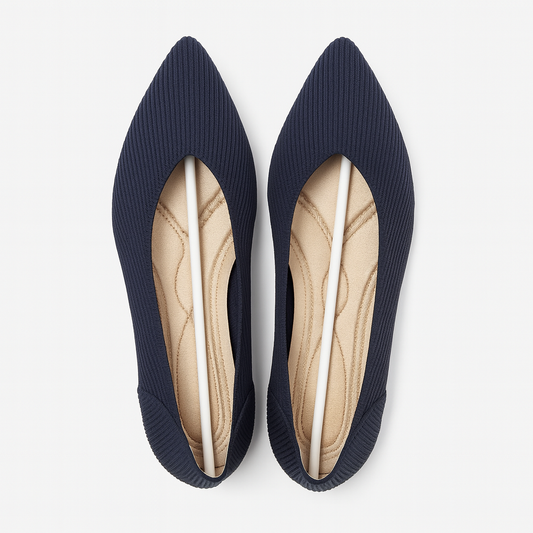Pair of navy blue pointed-toe flats on a white background